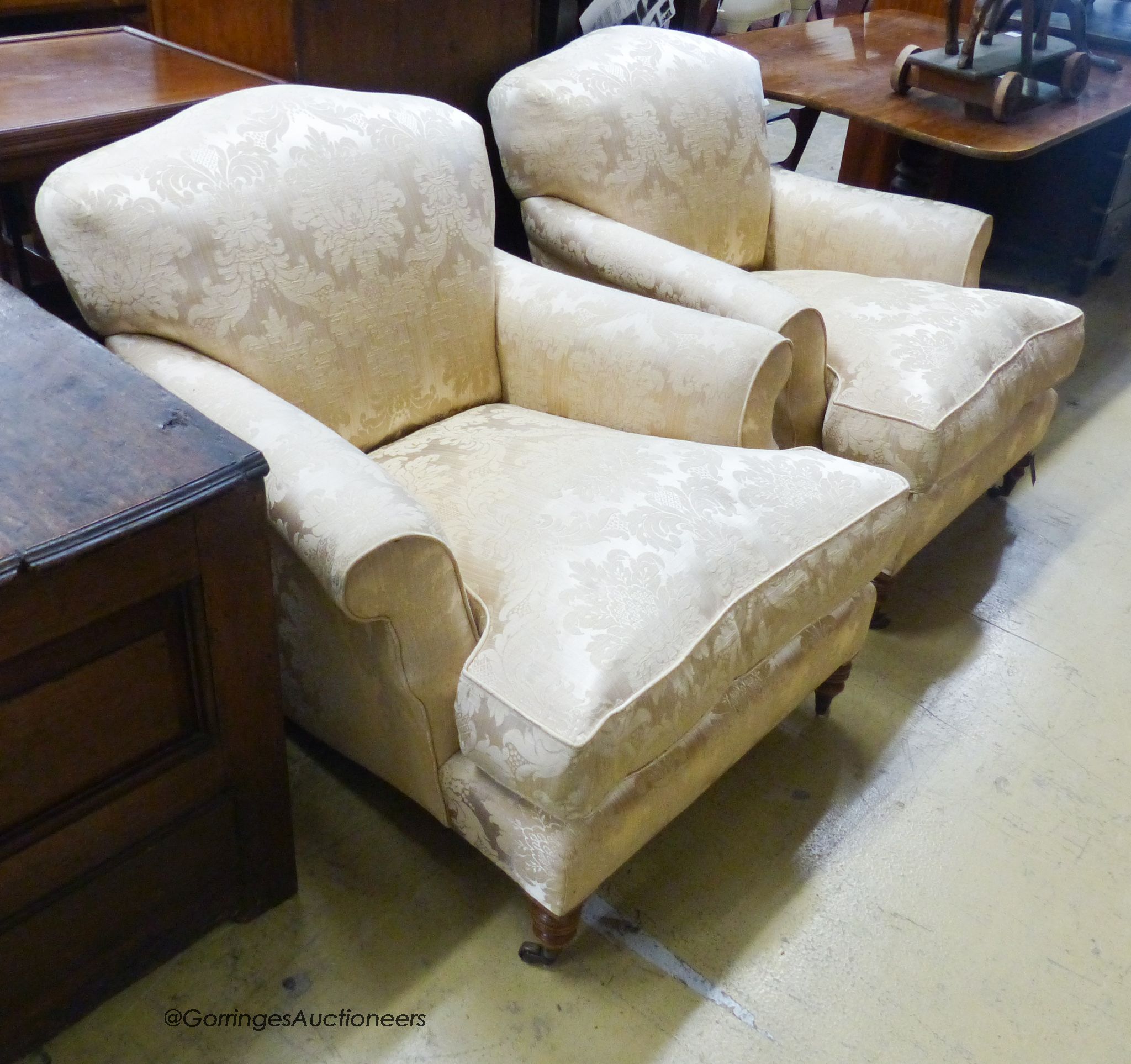 A pair of Howard style cream brocade upholstered lounge armchairs, width 85cm, depth 100cm, height 80cm
